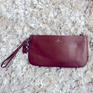 Brown Coach wristlet with gold accents